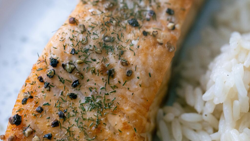 Grilled salmon and rice showcases an example of a lunch meal prep idea