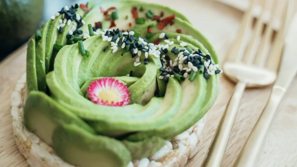 This image showcases a wonderful array of avocadoes topped with a variety of seeds. A prime example of benefits of a meal prep vegetarian