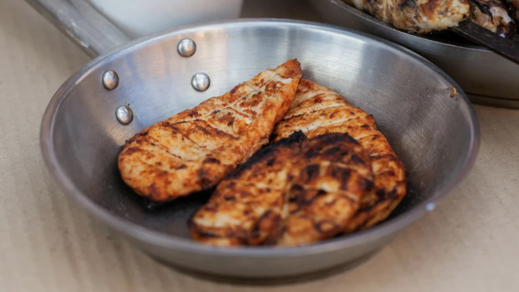 This image is a visual representation of high protein needs as it presents a stack of grilled chicken on a pan