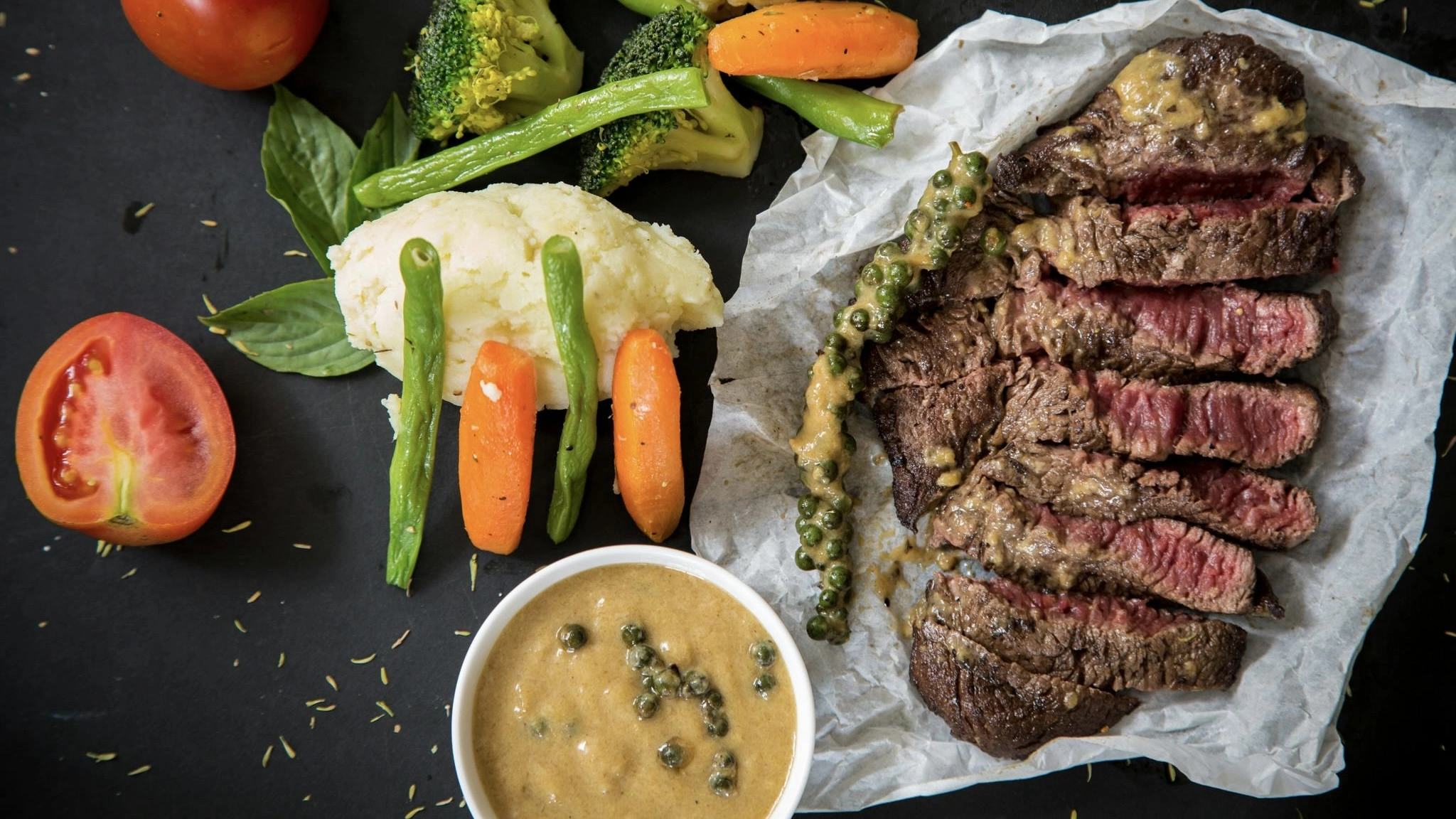 This image contains a large grilled ribeye steak that represents a high protein meal prep