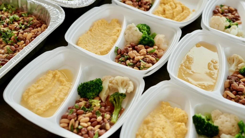 This image is a visual representation of a high protein meal prep routine. It contains eggs and beans spread across multiple containers.
